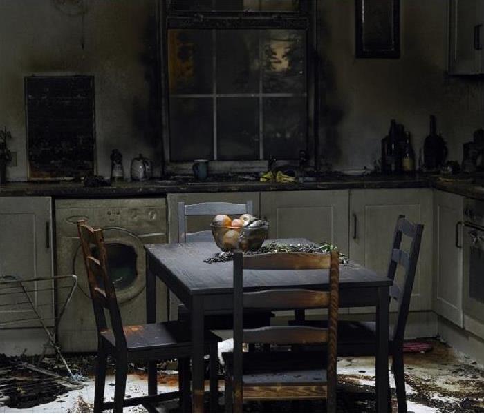 kitchen damaged by fire, smoke and soot on walls