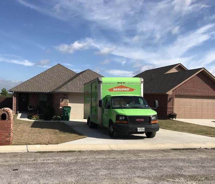 SERVPRO truck parked in a driveway. 