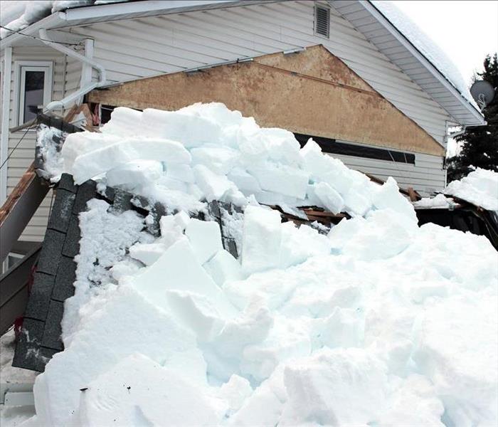 snow piled on roof, house, and car