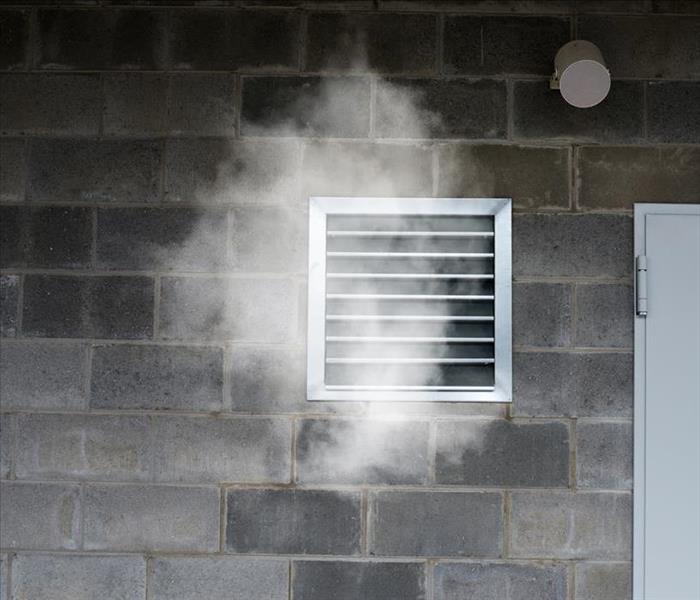 Block wall with air duct register circulating smoke